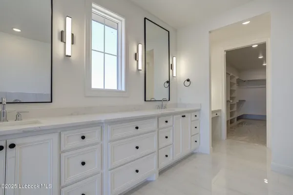 an empty room with a cabinet and mirrors