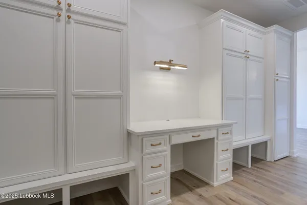 a bathroom with a double vanity sink mirror and bathtub