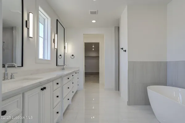 a bathroom with double sink and a mirror