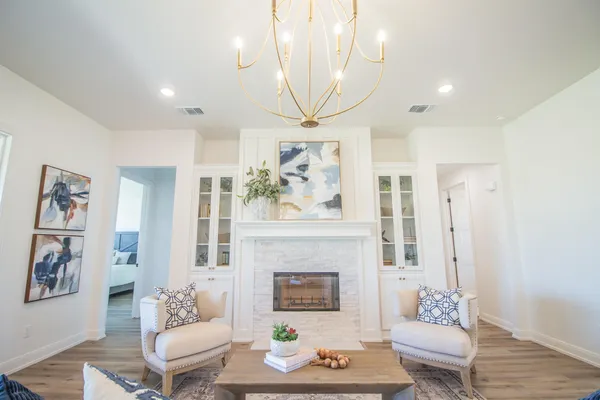 a living room with furniture a rug and a fireplace