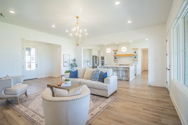 a living room with furniture and a chandelier