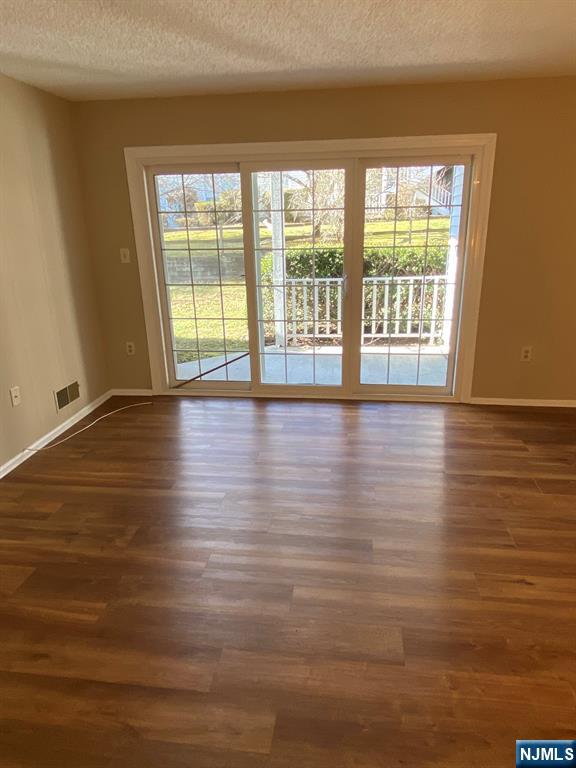 472 Quince Court Mahwah, NJ 07430 - Photo 3 of 8 a view of an empty room with wooden floor and a window