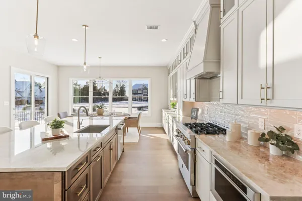 a kitchen with sink stove and cabinets