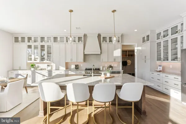 a dining room with furniture a chandelier and wooden floor