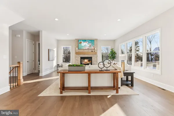 a living room with furniture a fireplace and a table