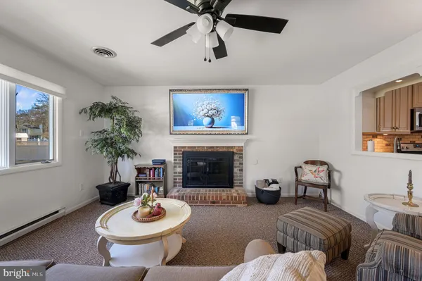 a living room with furniture a window and a fireplace