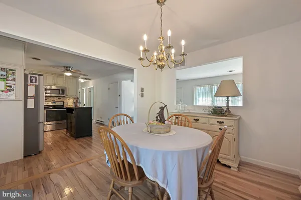 a view of a dining room with furniture and wooden floor