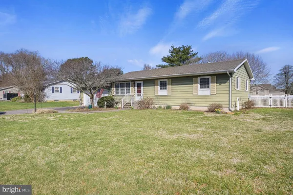a front view of house with yard and trees