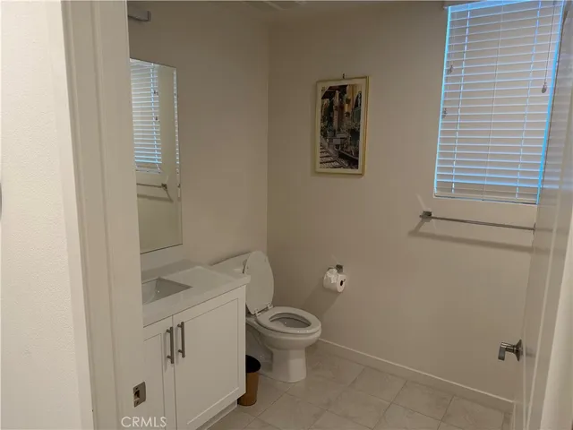 a white toilet sitting next to a small bathroom