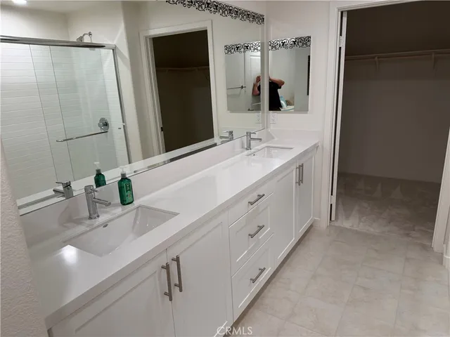 a bathroom with a double vanity sink mirror and double