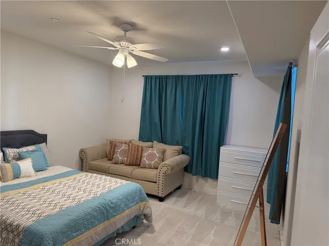 a bedroom with a bed and a couch