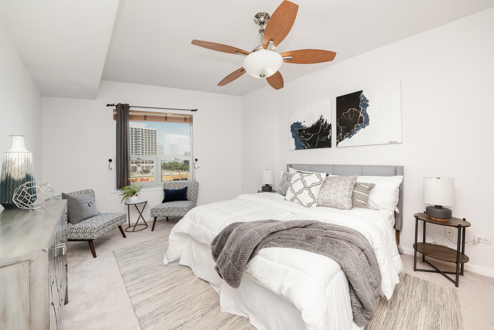4350 North Broadway, Unit 607 Chicago, IL 60613 - Photo 11 of 18 a bedroom with a bed and a chandelier