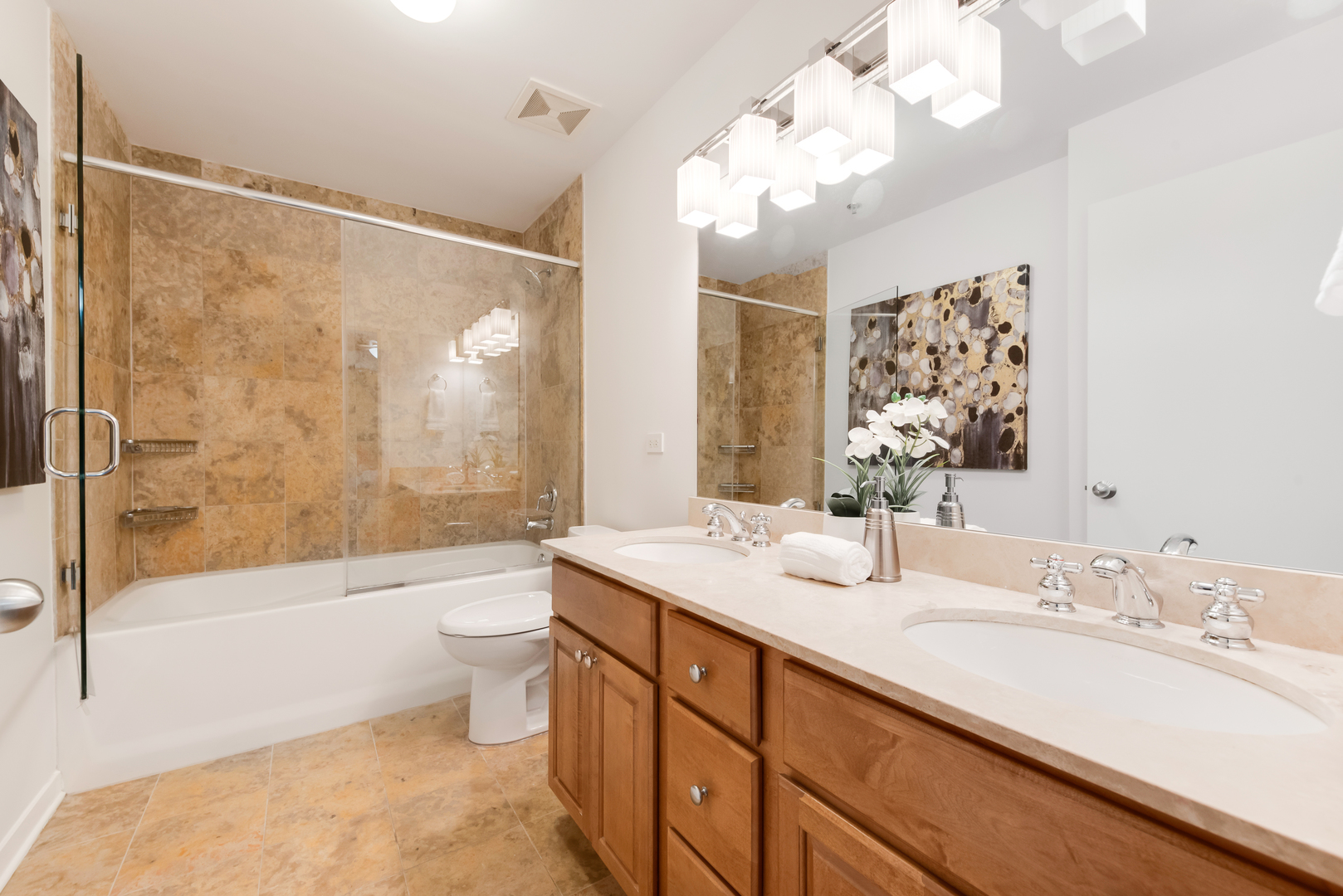 4350 North Broadway, Unit 607 Chicago, IL 60613 - Photo 13 of 18 a bathroom with a double vanity sink toilet mirror and shower