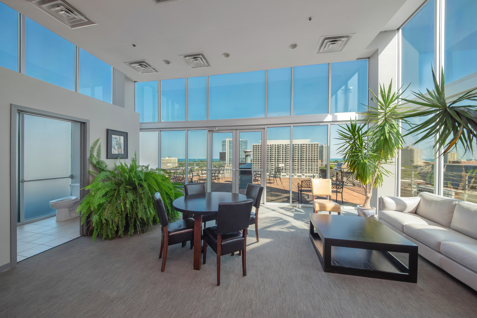 4350 North Broadway, Unit 607 Chicago, IL 60613 - Photo 17 of 18 a living room with furniture and a potted plant