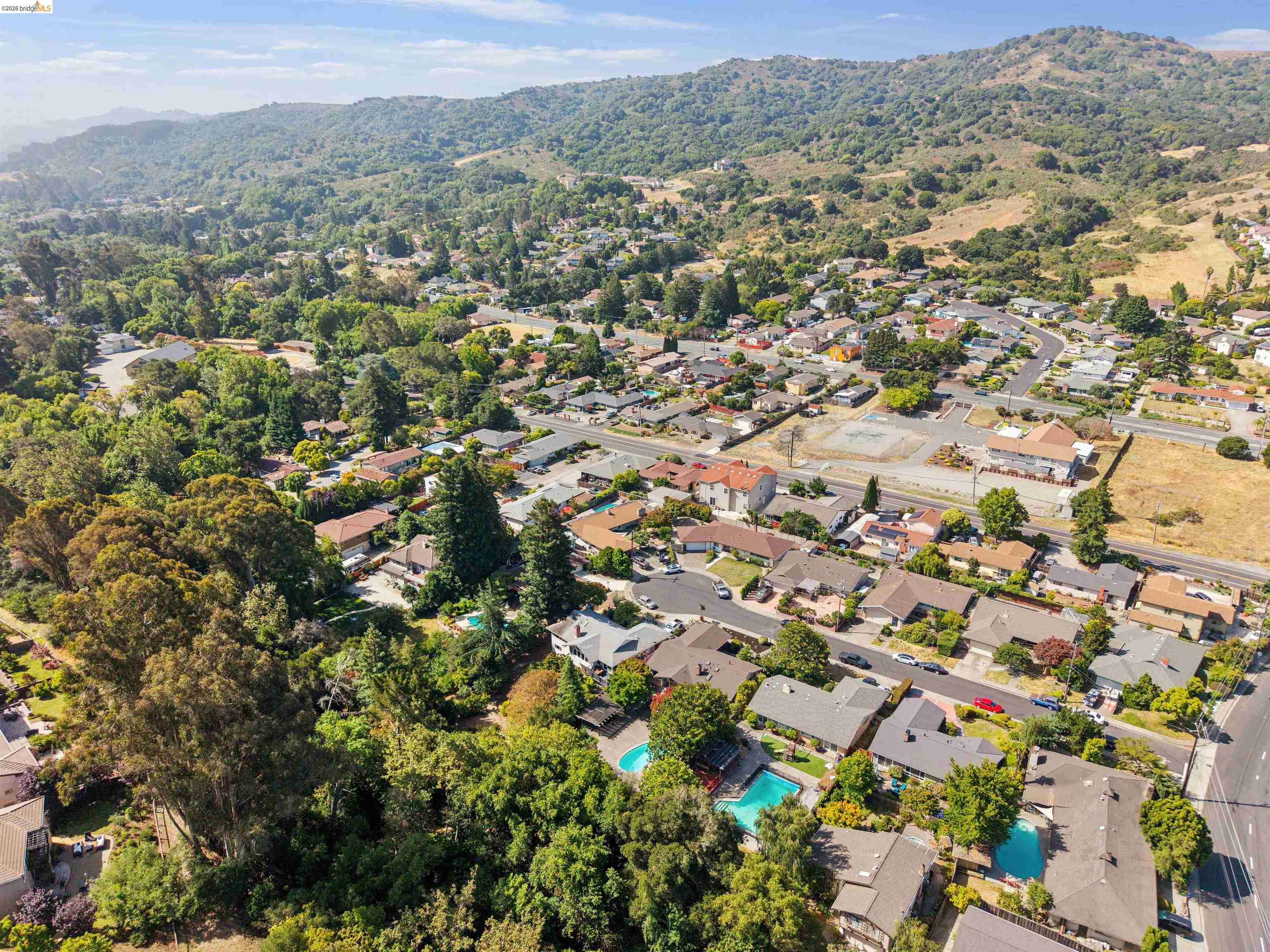 7 Jo Lin Court El Sobrante, CA 94803 - Photo 9 of 99 Aerial perspective showcasing a residential community nestled against a lush, tree-covered hillside