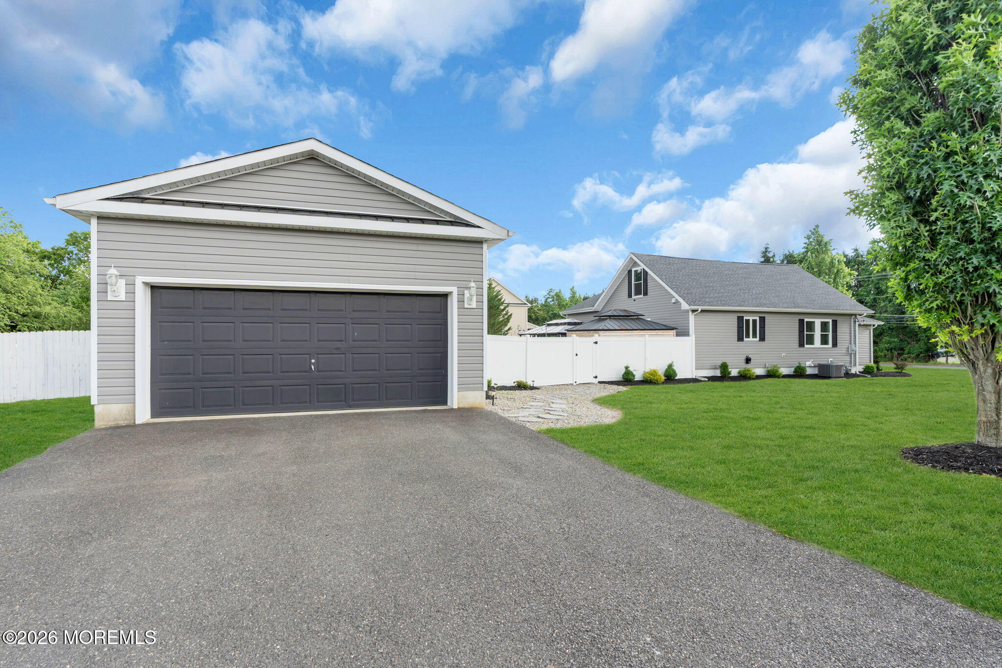 181 Locust Avenue Howell, NJ 07731 - Photo 58 of 66 a front view of a house with a yard and garage