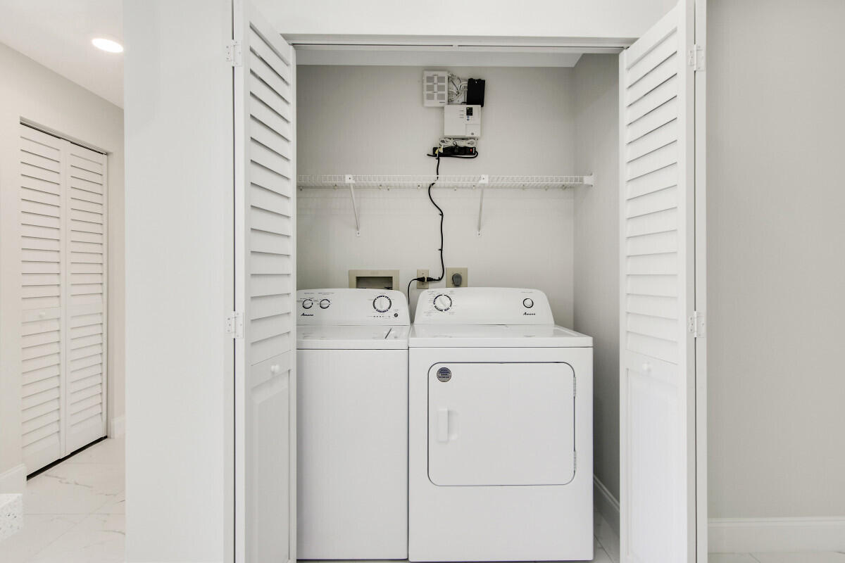 8641 Sunbird Place Boca Raton, FL 33496 - Photo 12 of 24 a utility room with dryer and washer