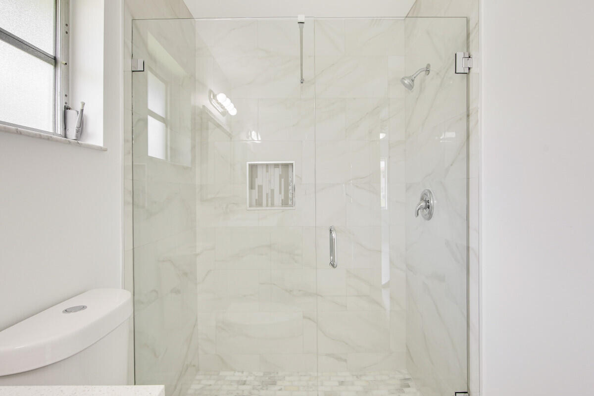 8641 Sunbird Place Boca Raton, FL 33496 - Photo 16 of 24 a bathroom with a shower and a toilet