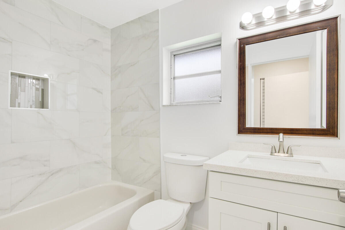 8641 Sunbird Place Boca Raton, FL 33496 - Photo 19 of 24 a bathroom with a sink toilet and shower