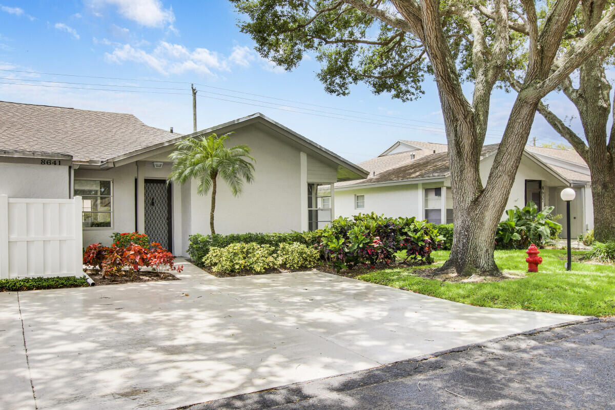 8641 Sunbird Place Boca Raton, FL 33496 - Photo 2 of 24 a front view of a house with garden