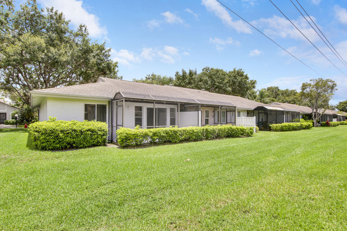 8641 Sunbird Place Boca Raton, FL 33496 - Photo 23 of 24 a front view of a house with a yard
