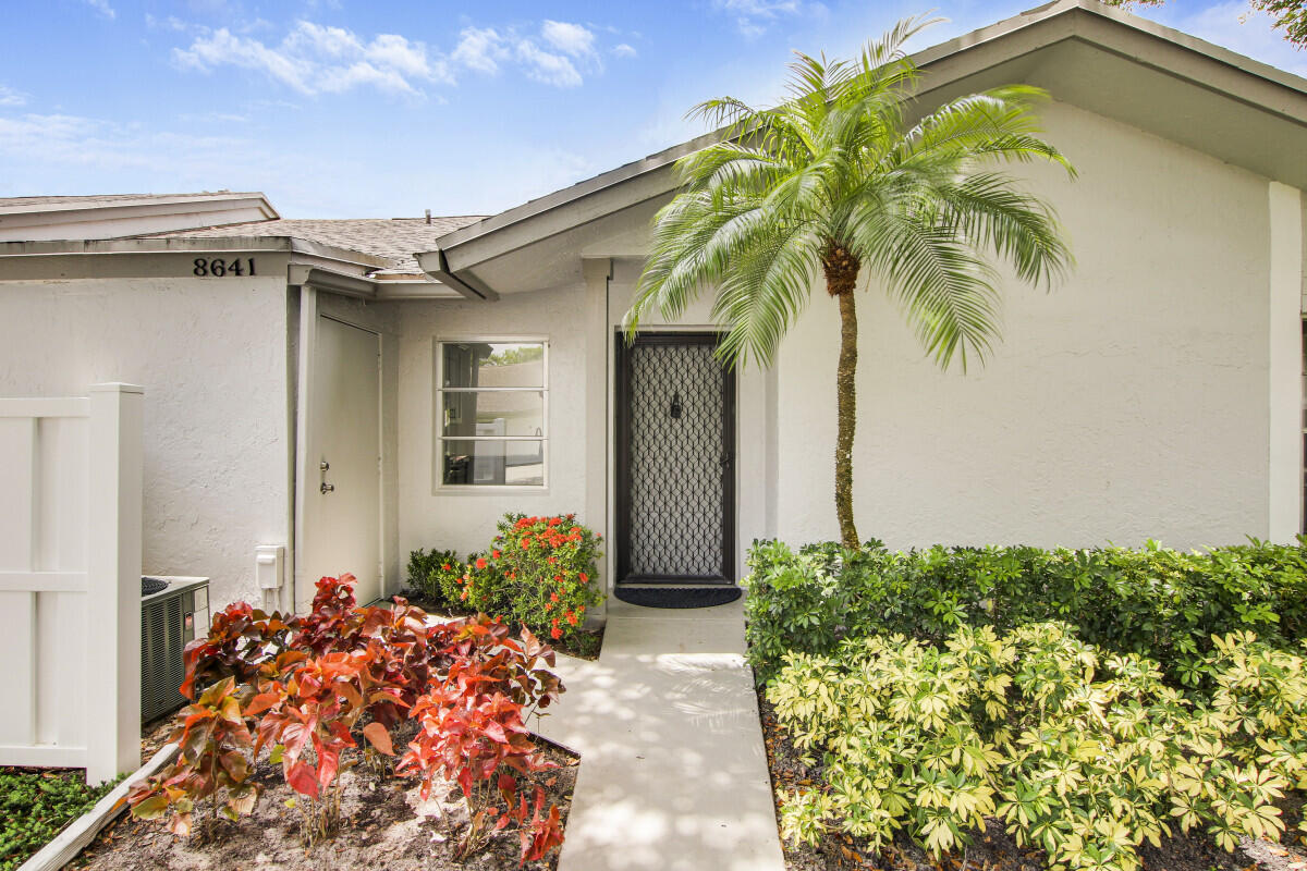 8641 Sunbird Place Boca Raton, FL 33496 - Photo 3 of 24 a front view of a house