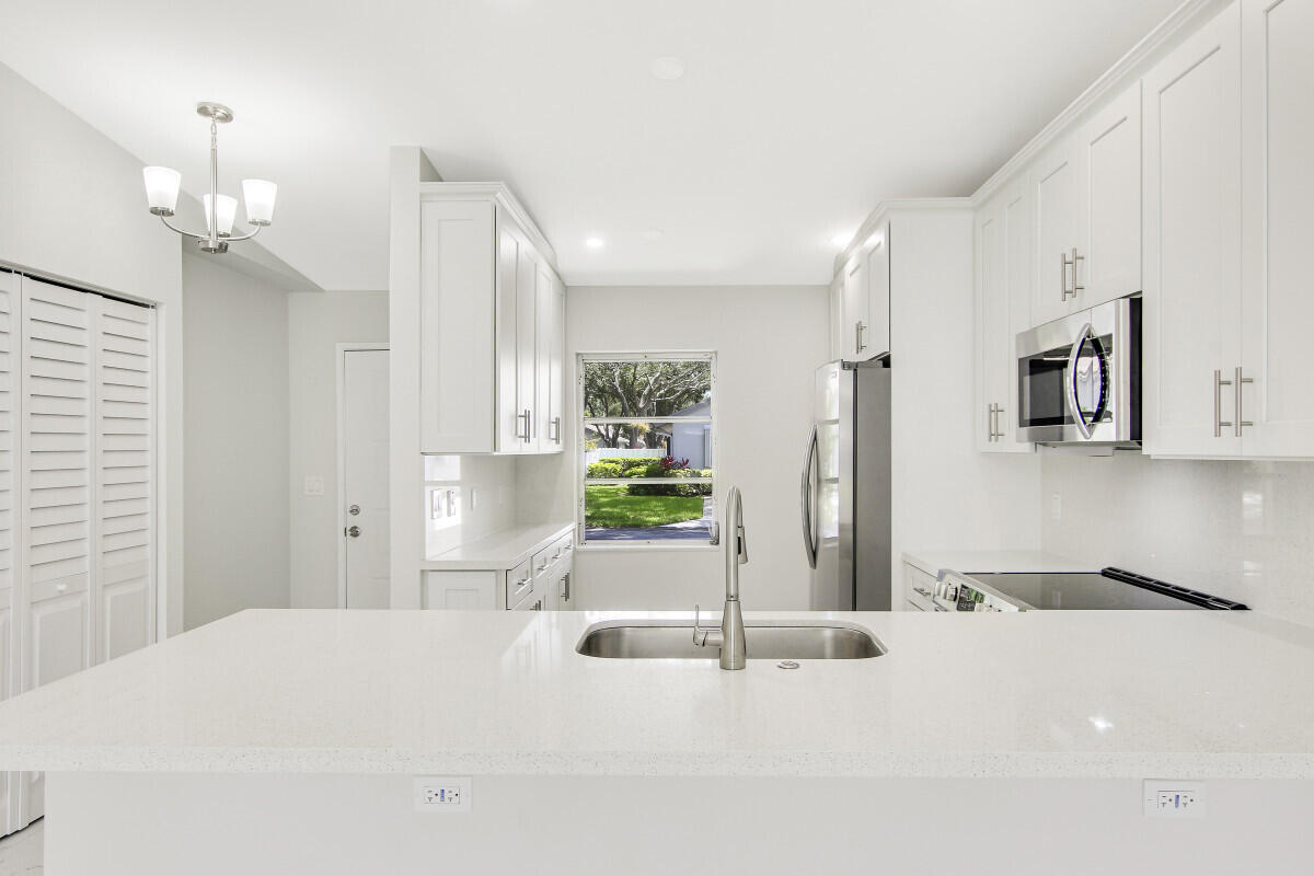 8641 Sunbird Place Boca Raton, FL 33496 - Photo 9 of 24 a room with a bed and ceiling fan