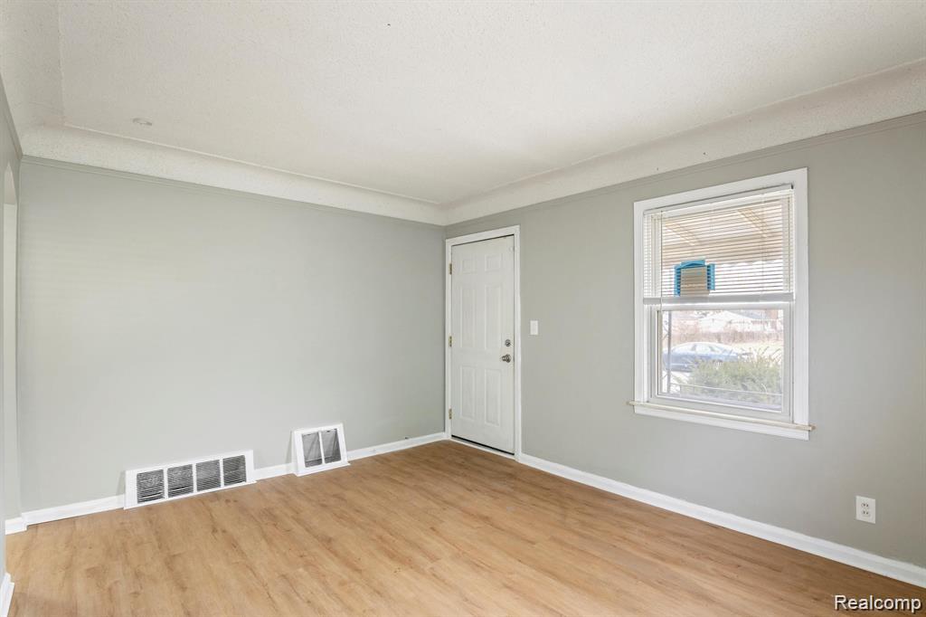 285 Campbell Street River Rouge, MI 48218 - Photo 6 of 33 Empty room with baseboards and light wood-style flooring