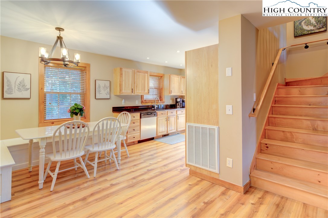 256 Holiday Hills Drive Boone, NC 28607 - Photo 14 of 34 a view of a dining room with furniture and wooden floor