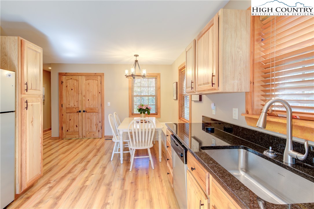 256 Holiday Hills Drive Boone, NC 28607 - Photo 17 of 34 a kitchen with granite countertop a sink stove and cabinets