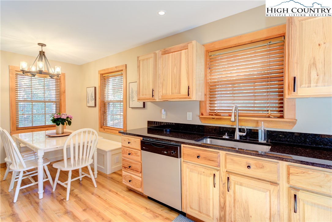 256 Holiday Hills Drive Boone, NC 28607 - Photo 18 of 34 a kitchen with granite countertop a stove a sink and white cabinets