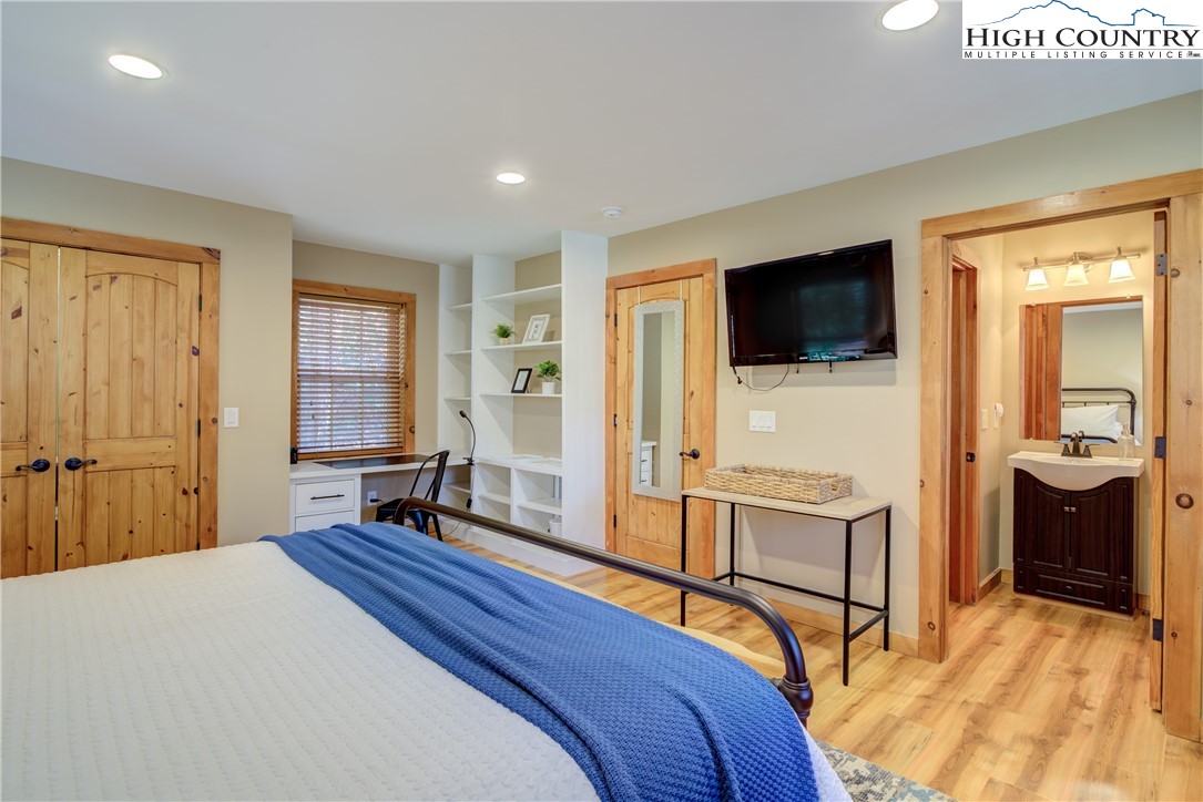 256 Holiday Hills Drive Boone, NC 28607 - Photo 21 of 34 a bedroom with a bed and a flat screen tv