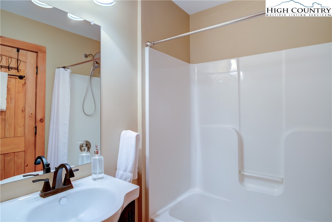 256 Holiday Hills Drive Boone, NC 28607 - Photo 22 of 34 a bathroom with a sink and a mirror