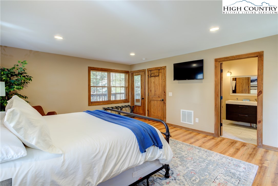 256 Holiday Hills Drive Boone, NC 28607 - Photo 24 of 34 a bedroom with a bed and a television