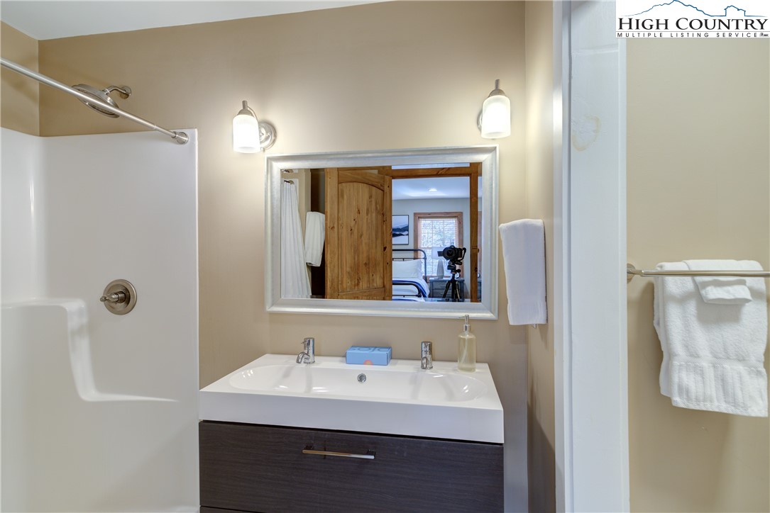 256 Holiday Hills Drive Boone, NC 28607 - Photo 25 of 34 a bathroom with a sink vanity and a mirror