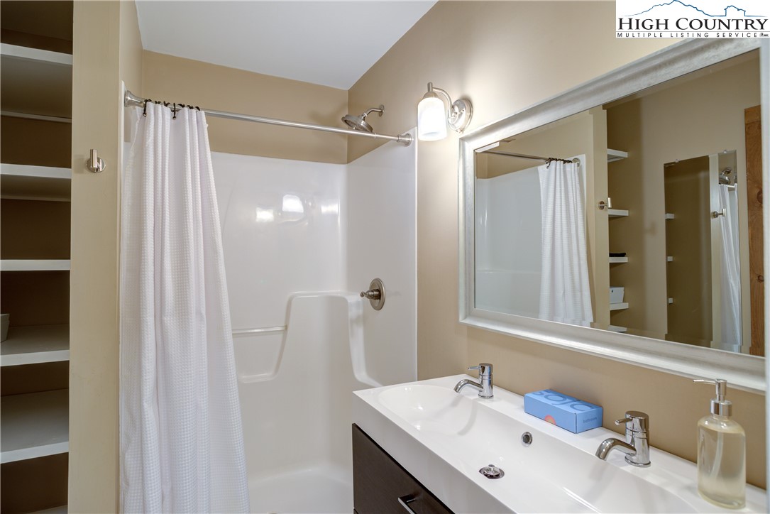 256 Holiday Hills Drive Boone, NC 28607 - Photo 26 of 34 a bathroom with a sink vanity and a mirror