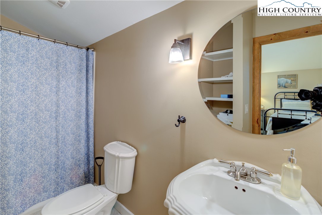 256 Holiday Hills Drive Boone, NC 28607 - Photo 30 of 34 a bathroom with a sink a toilet and mirror