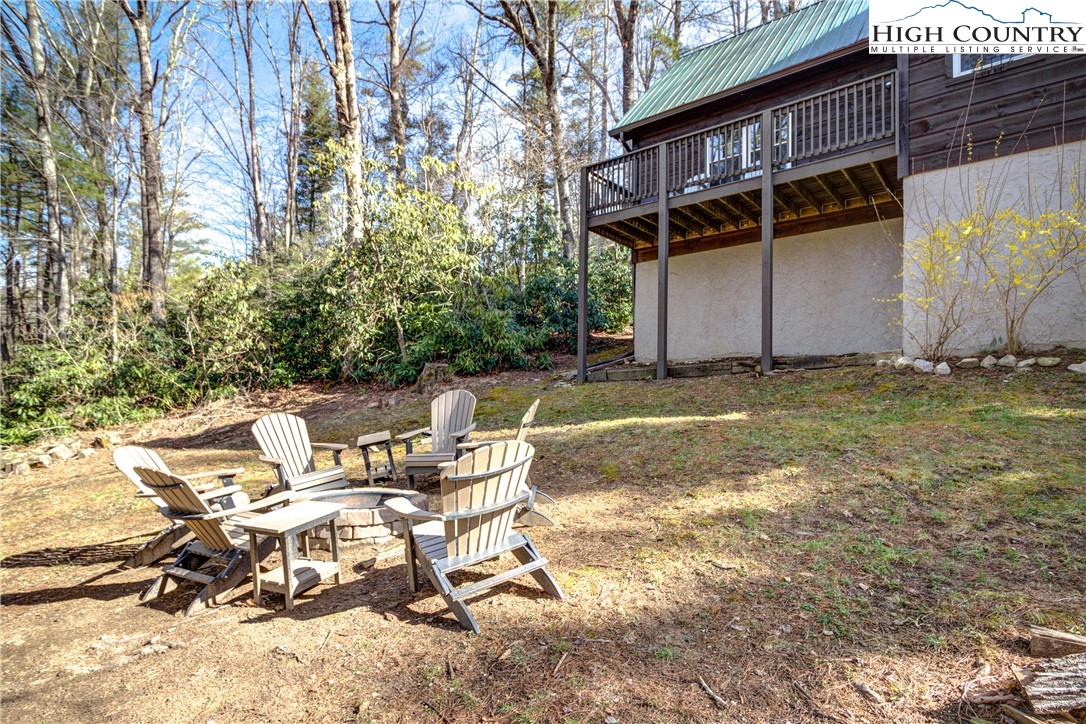 256 Holiday Hills Drive Boone, NC 28607 - Photo 3 of 34 a view of backyard with a table and chairs and a large tree
