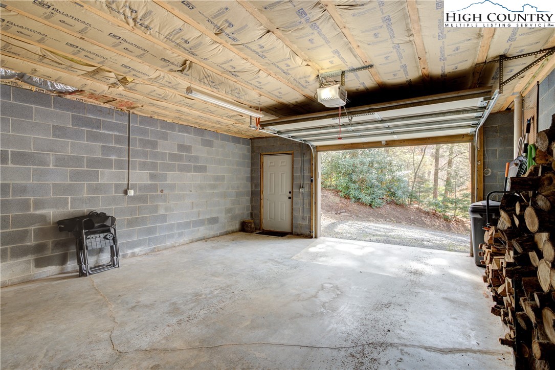 256 Holiday Hills Drive Boone, NC 28607 - Photo 32 of 34 a view of an empty room with wooden floor and chair