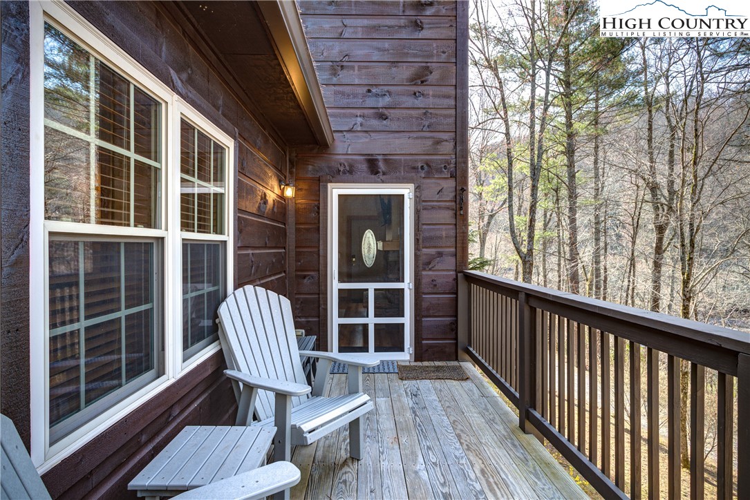 256 Holiday Hills Drive Boone, NC 28607 - Photo 8 of 34 a view of chair in balcony with wooden floor