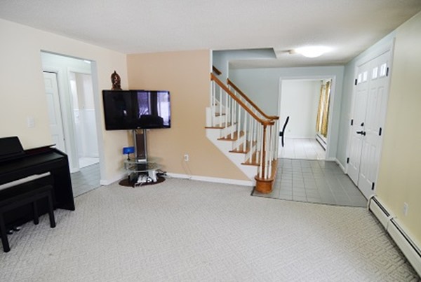3 Eclipse Avenue Chelmsford, MA 01824 - Photo 5 of 6 a view of game room with windows and ceiling fan