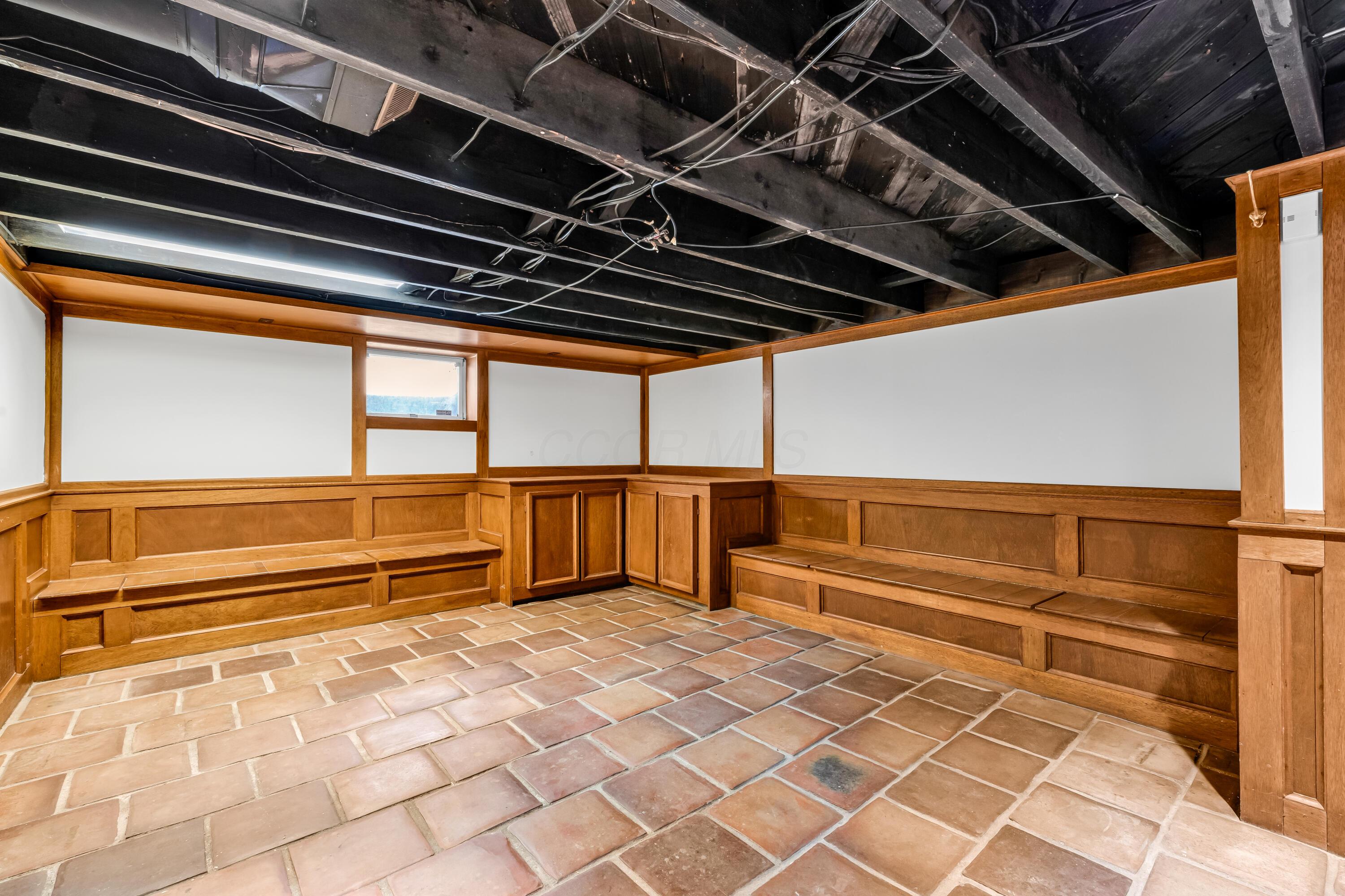 2033 Zollinger Road Columbus, OH 43221 - Photo 27 of 44 • Ceramic tile flooring
• Ivory painted & wainscoted
walls
• Built-in seating & storage
• Can lighting
• Lighted cedar closet
• Stone fireplace with
woodburning insert
• Built-in bookcases
• Water meter access
