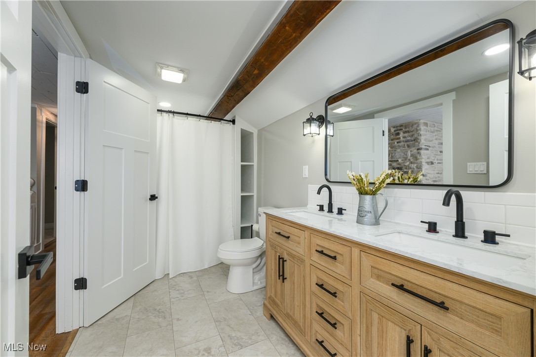 3029 Werner Church Road Northeast Canton, OH 44721 - Photo 21 of 33 Bathroom featuring backsplash, tile patterned flooring, toilet, and vanity