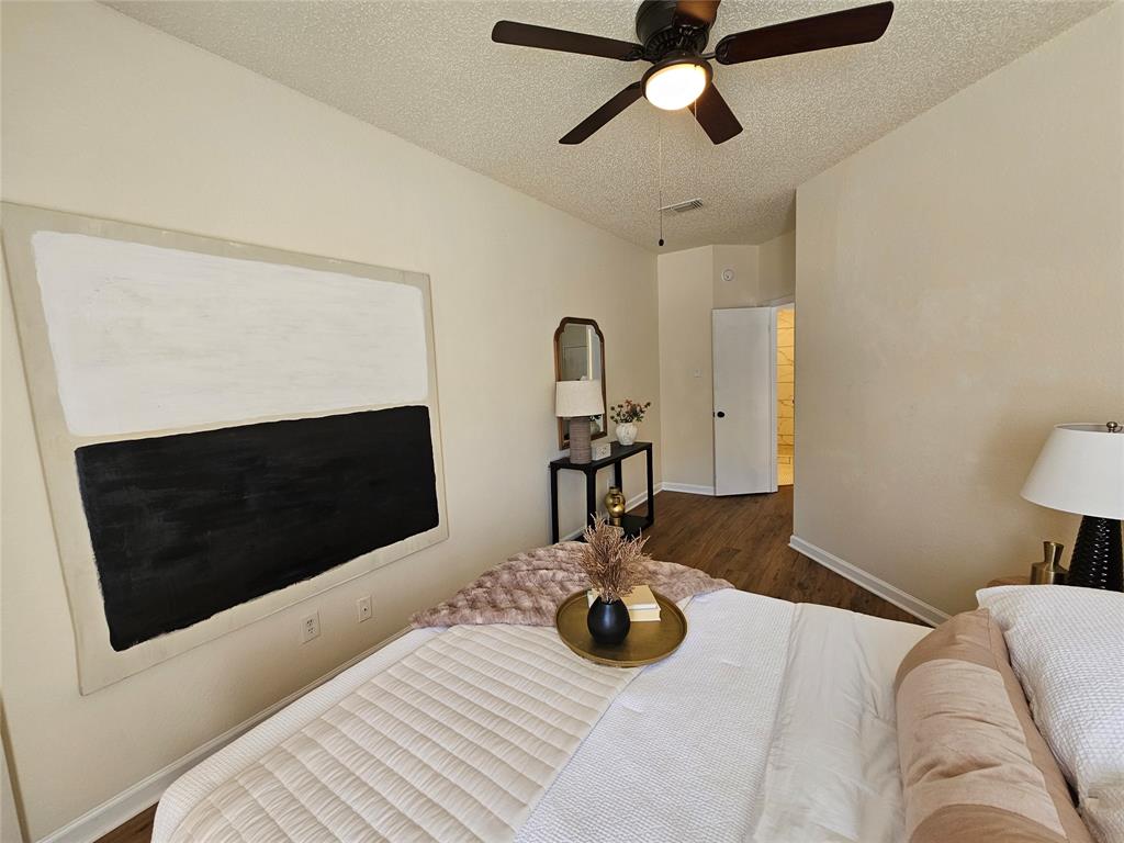 5550 Spring Valley Road, Unit C14 Dallas, TX 75254 - Photo 20 of 21 Bedroom featuring wood-finish flooring, a ceiling fan with integrated lighting, and light-toned walls