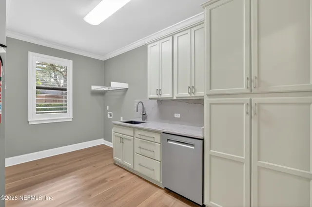 a view of swimming pool with a table and chairs under an umbrella