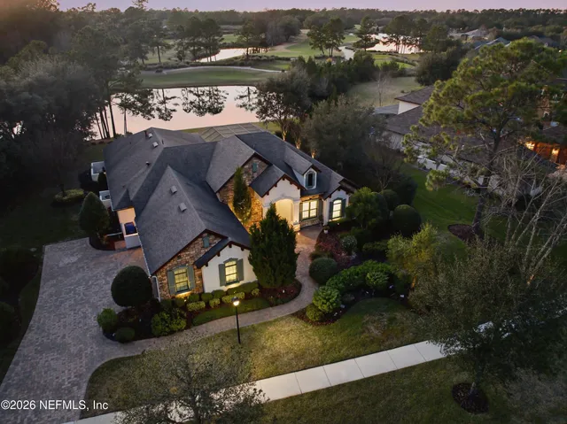 an aerial view of a house with a lake view