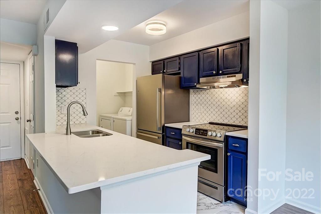 11019 Running Ridge Rd. Charlotte, NC 28226 - Photo 1 of 31 a kitchen with a refrigerator and a stove top oven