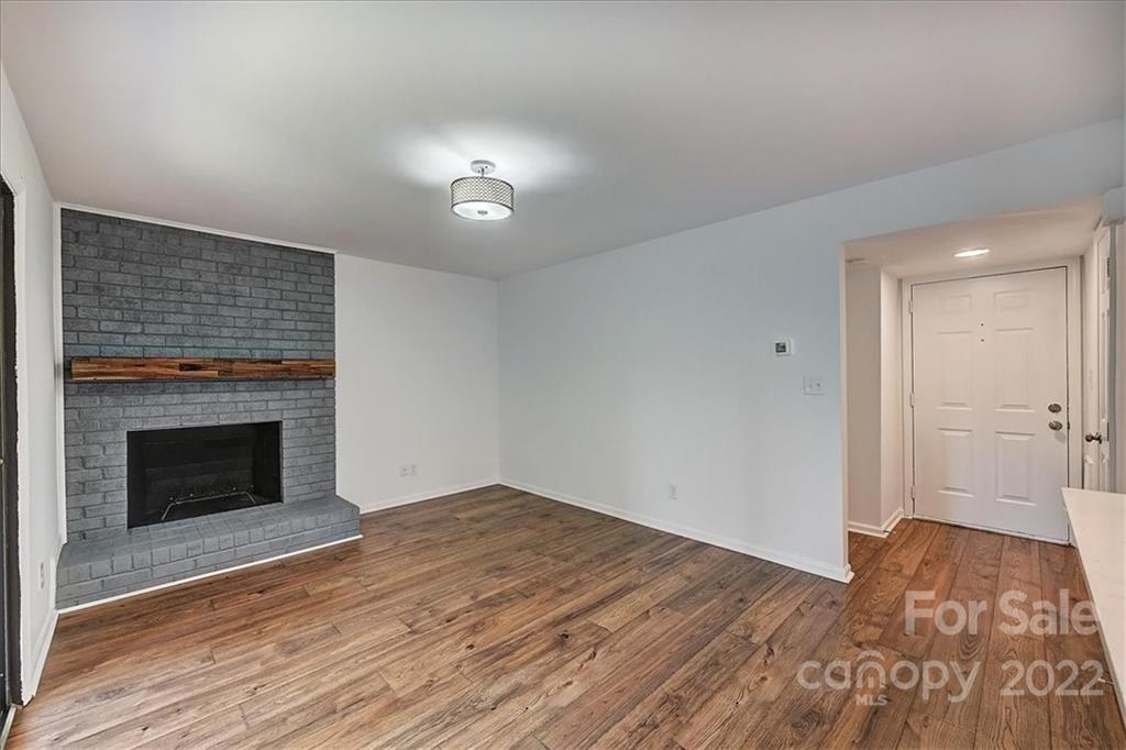 11019 Running Ridge Rd. Charlotte, NC 28226 - Photo 12 of 31 a view of empty room with wooden floor and fireplace