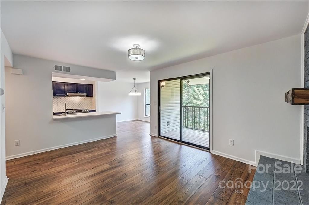 11019 Running Ridge Rd. Charlotte, NC 28226 - Photo 15 of 31 an empty room with wooden floor and windows