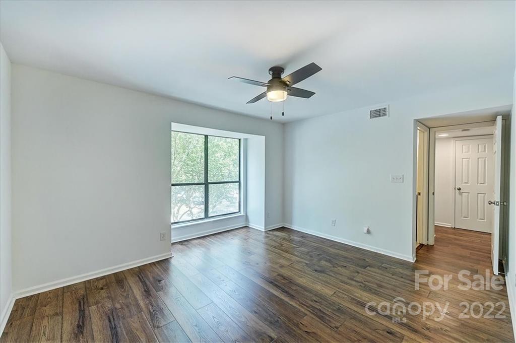 11019 Running Ridge Rd. Charlotte, NC 28226 - Photo 18 of 31 a view of empty room with wooden floor and fan